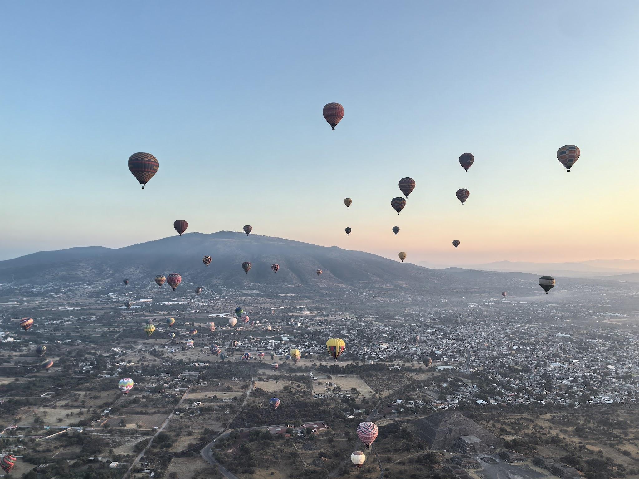 Hot air balloons flying in the sunrise sky