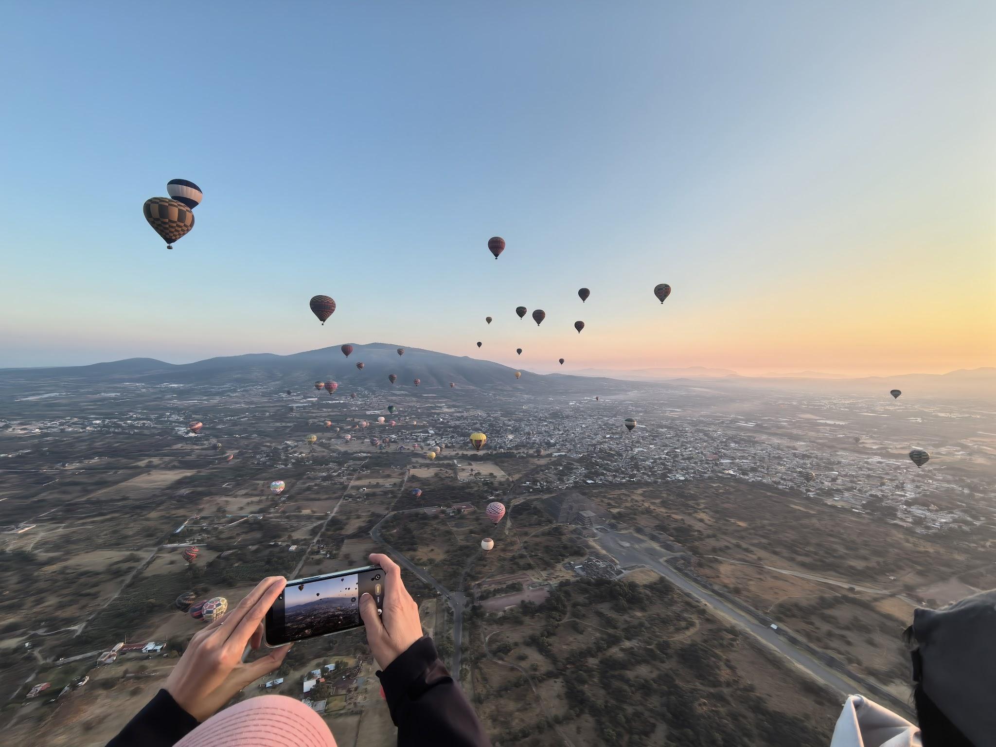 A hot air balloon rising near other balloons