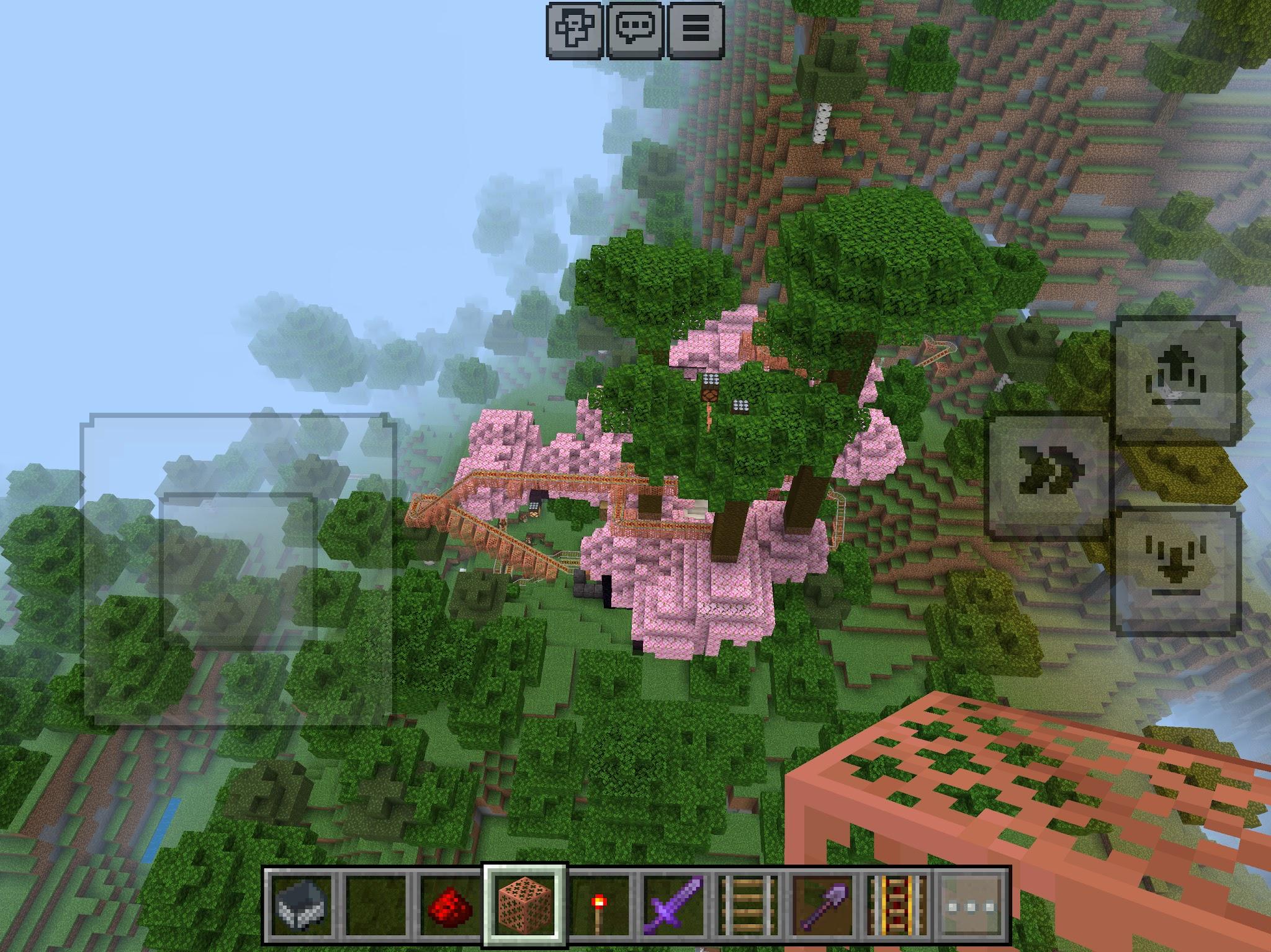 Minecraft territory with a cherry tree biome and rollercoaster